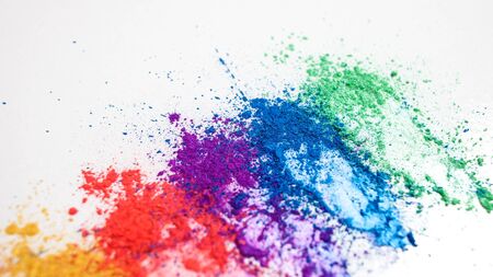 Bright eye shadows in different colors of the rainbow, scattered on a white background. Creative...