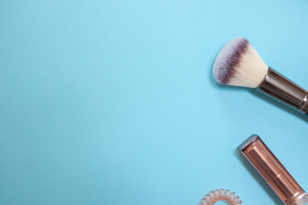 flat lay template in a modern business style on a blue background, contents of women's handbag, phone, cosmetics and watchesの写真素材