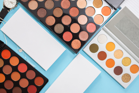 Large sets of eye shadows and concealers, cosmetics for professional makeup artist, blue backgroundの写真素材