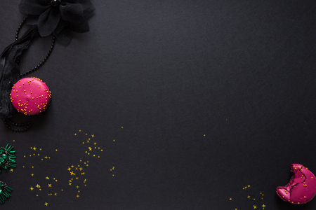flat lay template, in glamorous chic style, black background, scarlet lipstick and gold sequins. free space in the centerの写真素材