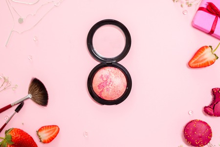 Cute pink flat lay, template. Glamorous style, elements cosmetics and sweets on frameの写真素材