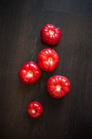 Fresh tomatoes on a wooden table. Healthy diet. Fresh tasty vegetablesの写真素材