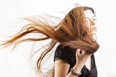 Beautiful long-haired young woman has a dream. white backgroundの写真素材