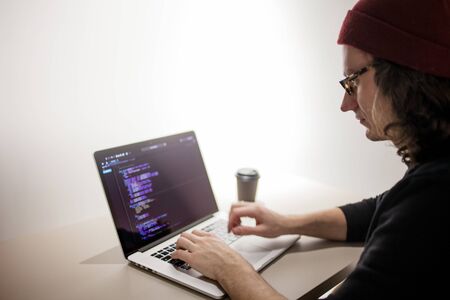 Programmer and coder working in the development environment. Programmer's workplace, laptop with project codeの写真素材
