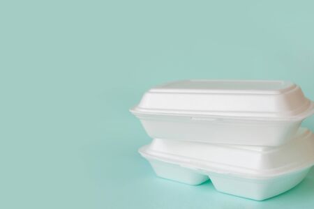 Food delivery service from cafes and restaurants. Food containers on light blue background, copy spaceの写真素材
