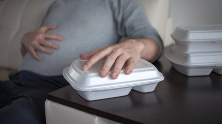 Food delivery from the restaurant. Problems of poor quality products and food allergies. The problem of overeating, eating disorders.の写真素材