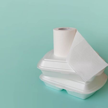 Food delivery, low quality problems. Food containers and toilet paper roll, food poisoning and diarrhea, conceptの写真素材