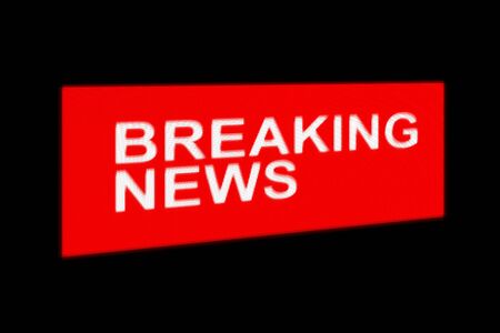 Breaking news, red sign. News release, mark for urgent information, text on black backgroundの写真素材