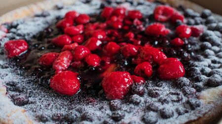 Melon cut into small pieces on a blue background, fresh fruit for snacks, healthy food. copy space from bottomの写真素材