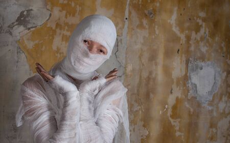 Halloween image, mummy in bandages, risen dead legendary character. Cute mummy makes funny gestures, funny concept-Happy Halloweenの写真素材