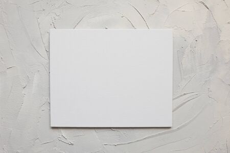 Gray textured concrete background, copy space for design. Trend texture of cement or rough surface, loft grunge style. Blank white canvas in the center.の写真素材