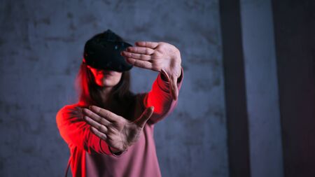 Reboot A young woman in virtual glasses spreads her arms in a characteristic gesture. Setting up a...