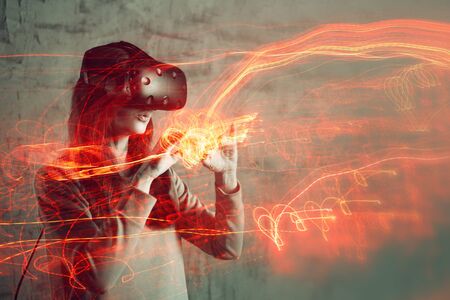 girl uses virtual reality helmet, concept of modern technology, effect of double exposure. Young...