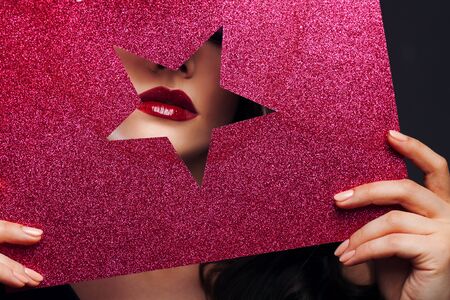 Sexy female lips in a star-shaped cutout. Bright makeup for a superstar, fragmentの写真素材