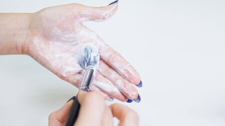 Hygienic care of makeup artist tools, women's hands wash the brush from cosmetics, soap and cleaning...