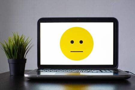 Digital assistant and chat bot, calm face on laptop screen, intelligent systemsの写真素材