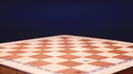 Chess, empty chessboard on a dark background, copy space
