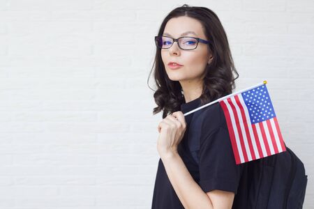 young woman with the flag of the United States of America. The study of American English language...