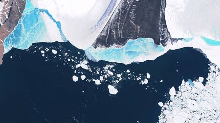Glacier in Greenland, blocks of ice floating in the ocean, seasonal changes in glaciers. contains modified Copernicus Sentinel dataの写真素材