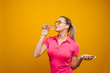 Healthy habits, an app to track the amount of water you drink. Young woman with a bottle of water...