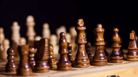 Wooden chess in a contrasting light. A game of chess, an intellectual competition, a concept of...
