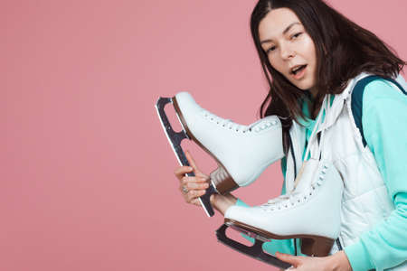 Figure skating for adults, Hobbies and a healthy lifestyle. A young woman in a bright sweatshirt...