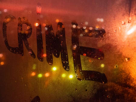 Crime, detective story, case of violation of the law. Inscription on the fogged glass, night city on...