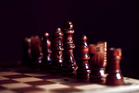 Wooden chess in a contrasting light. A game of chess, an intellectual competition, a concept of...