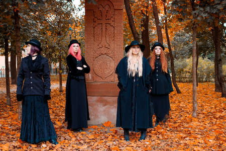 Coven of witches, a group of different friends as witches meet Halloween. Young women in black...