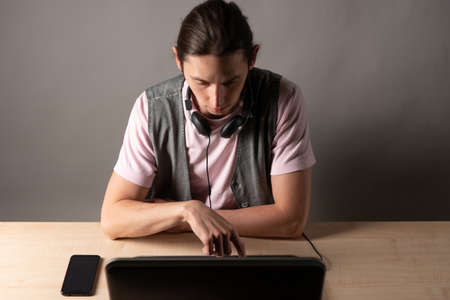 Write code and learn programming languages. A student or specialist is doing a project. The guy is a...