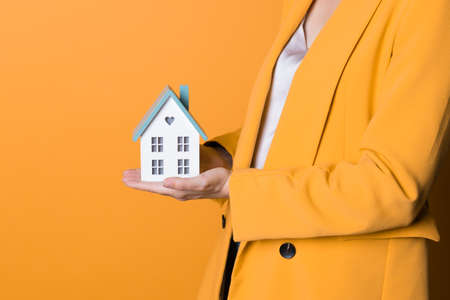 Take a mortgage, lending for the purchase of real estate. A young woman with a small house in her...