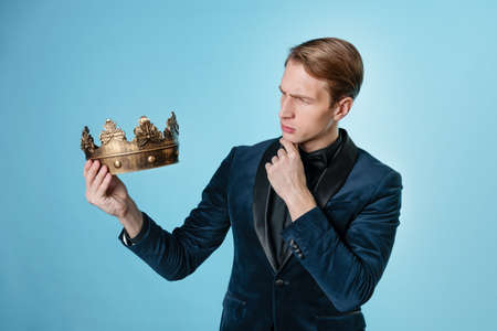Get the crown, the concept of leadership and gaining privileges. VIP person. A young attractive man...