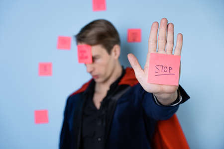 Superhero tired, emotional burnout at work. Forgetfulness and fatigue due to professional burnoutの写真素材