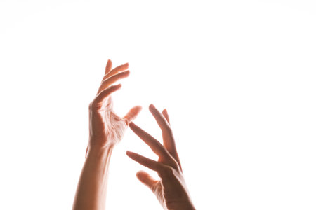 Hand gestures. Elegant womens hands catch something that falls from above, isolated on white,...