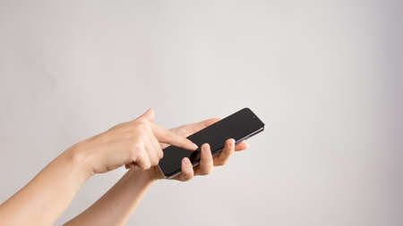 Use mobile apps, scroll. Smartphone, the female hand uses the touchpad, Layout for design, mockup....