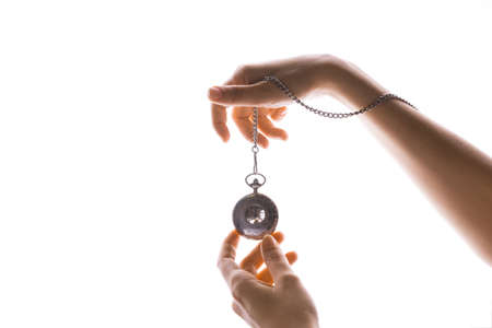 Vintage pocket watch on a chain in a womans hand. Time passes, the moment has come, the concept of...