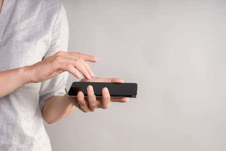 smartphone with a touch screen in a womans hand. Use your phone with a touchpad, layout for your design.の写真素材