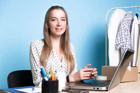 Small business, young female entrepreneur working at a Desk,