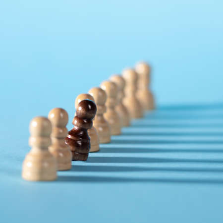 chess pieces in a row, white pawns on a blue background,の写真素材