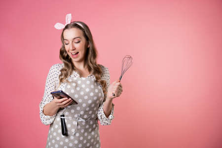 Young charming woman pastry chef communicates with customers by phone, take orders, entrepreneur.の写真素材