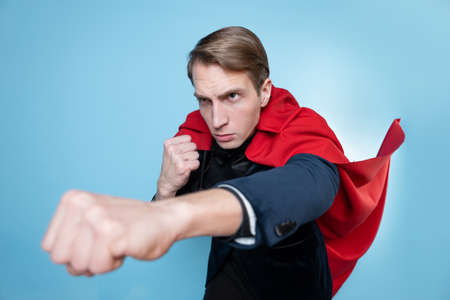Super man fights with enemies. Businessman in a suit with a red cape,の写真素材