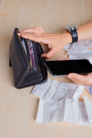 Personal Finance, the woman considers the costs, receipts and invoices,