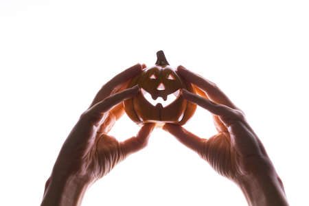 Halloween party. womens hands hold a Halloween pumpkin with a Jacks smile,の写真素材