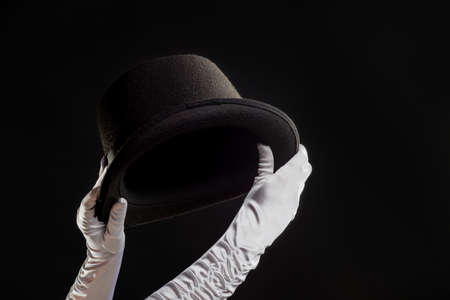 Hand gestures. The magician shows tricks with a hat.の写真素材