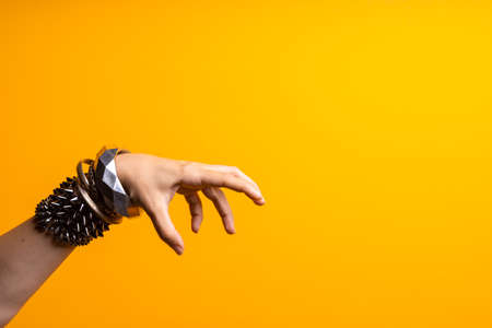 Hand gestures. Womens hand with lots of bracelets, youth fun style.の写真素材