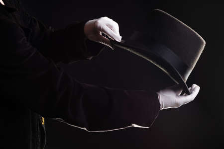 Hand gestures. The magician shows tricks with a hat.の写真素材