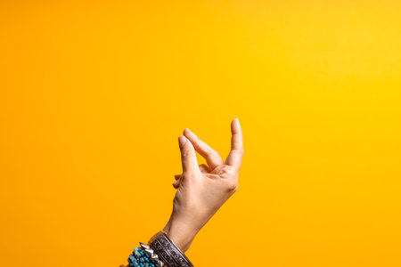 Hand gestures. Click your finger. Womens hand with lots of bracelets, youth fun style.の写真素材