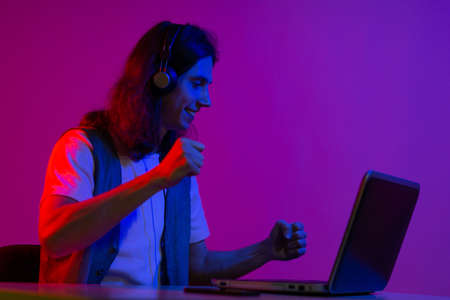 Online programming training, computer programmer or student. A young man with long hair and headphones.の写真素材