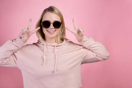 beautiful young woman with blonde hair wearing dark sunglasses.の写真素材