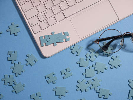 Puzzle elements in a chain of several blocks on a laptop keyboard,の写真素材